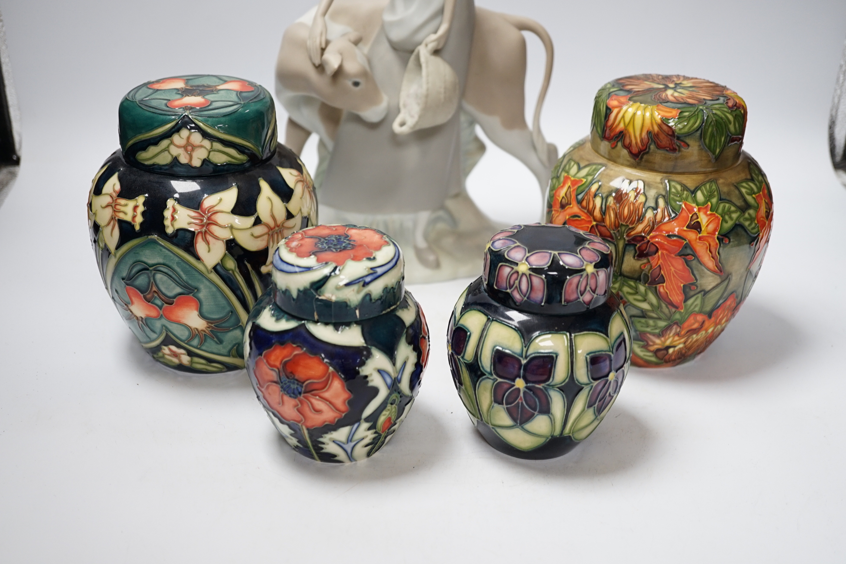 Four modern Moorcroft jars and covers, largest 16cm high, three boxed and a Nao figure group, tallest 95cm high